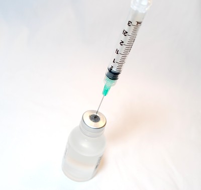 image of needle and phial illustrating an article about influenza vaccine and coronavirus